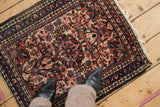 A standing view of the vintage Dargezine rug showing the scale of its dense floral pattern.