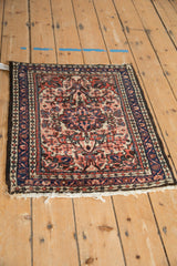 Angled view of a vintage Dargezine rug showing its floral pattern and dark side cords.