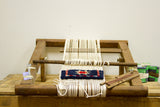 Table Top Rug Loom with hand-knotted blue and red geometric pattern taking shape.