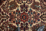 Central medallion and floral bouquets in navy, terracotta, and sky blue on a fine Borchalou rug.