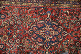Textured pile of a vintage Borchalou rug, featuring a scalloped medallion.