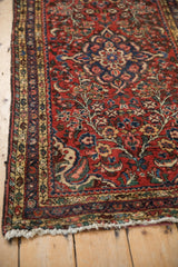 Vintage Borchalou rug's brick red main border with vine palmettes and blue boteh minor borders.