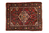 Vintage Dargezine rug mat with colorful floral medallion on a cherry red field, 2'2