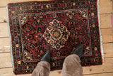 Vintage Dargezine rug mat, colorful floral medallion and sprays on a cherry red field.