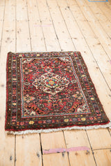 Vintage Dargezine rug corner with cherry red field, colorful floral sprays, dark bronze border.