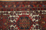 Hand-knotted Karaja rug detail showing hook and latch motifs in red, navy, and ivory.