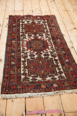 Vintage Karaja Persian runner from an angle showing the red and blue triple medallions.