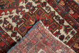 Detail showing the original polychromatic selvage and hand-knotted back of a vintage Karaja rug.