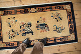 Vintage hand knotted Peking rug corner, intact selvage, dark navy geometric border, floral motif.