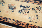 Angled close-up of vintage Chinese rug, with pictorial vases and apricot floral motifs.