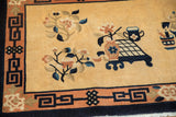 Vintage Chinese Peking rug corner with apricot fretwork border and floral designs.