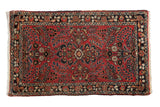 Vintage Dargezine rug with a floral medallion on a dusty brick red field with navy blue and sand accents.