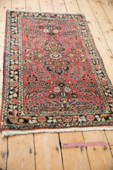 Angled view of a vintage Dargezine rug highlighting its hand-knotted floral design and border.