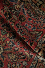 Soft, hand-knotted pile of a vintage Dargezine rug with dusty red and navy floral sprays.