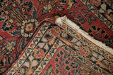 Folded corner of a vintage Dargezine rug showing its hand-knotted reverse and short, secure fringe.