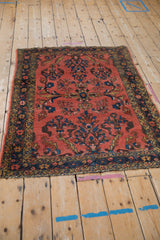 Vintage Lilihan rug upper right corner, dark coral field, sapphire blue starburst border.