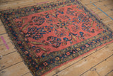 Vintage Lilihan rug corner detail: coral field with sapphire blue vines and patterned borders.