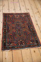 Mehriban rug corner detail: brick red field with sapphire blue millefleur and colorful boteh border.