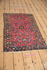Antique Lilihan rug's nuanced serrated medallion and expressive scrolling vines on ruby red.