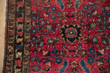 Detail of antique Lilihan rug: hand-knotted border and expressive scrolling vines in rich gem-tones.