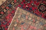Close-up of antique Lilihan rug's hand-knotted foundation, fringed edge, and characteristic painted back.