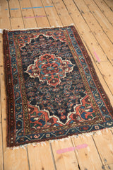 Vintage Dargezine rug's tattered aubergine side, showing dusty raspberry vine boteh border.