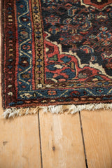 Vintage Dargezine rug corner featuring tattered fringe, red vine boteh, and blue pearl seed borders.