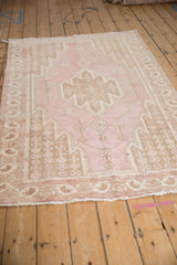 Distressed Mazlaghan rug detail, pale pink field with pale coffee brown stepped vinery.