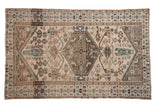 Distressed vintage Hamadan rug with hexagonal medallion, Herati patterns, muted beige and faded green.