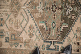 Faded emerald green and brown Herati motifs on beige distressed Hamadan pile.