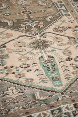 Distressed vintage Hamadan rug finial and cypress tree motif in beige, green, brown.
