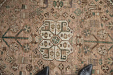 Hand-knotted vintage Qashqai rug in dusty mauve with quatrefoil and boteh patterns.