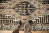 Vintage Mazlaghan rug pattern showing sharp serrated medallion, stepped vinery, and earthy tones with wear.