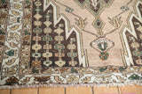Vintage Mazlaghan rug corner: multi-tiered borders with stylized elements and fringed edge.