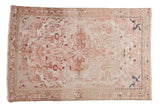 Distressed vintage Hamadan rug featuring a faded starburst medallion in soft pink and neutral tones.