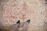 Faded pink starburst medallion and ivory, pale coffee brown floral motifs.