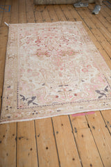 Distressed vintage Hamadan corner, showing even wear, fringe, and pale pink, ivory, and sand floral design.