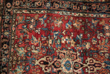 Vintage Bijar rug section: cherry red field with intricate floral blossoms and Herati Samovar border.