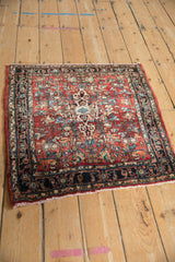 Upper corner of a Vintage Bijar rug, featuring navy Herati border and cherry red floral field.