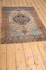 Antique Farahan Sarouk rug corner, intricate terracotta border, delicate floral vinery, and softened fringe.