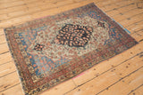Antique Farahan Sarouk rug corner, terracotta and beige borders, vivid blue spandrel detail.