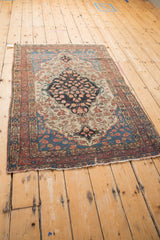 Antique Farahan Sarouk rug corner with abrashed blue spandrel, delicate floral motifs, and mostly even wear.