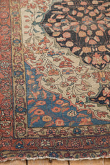 Fine Antique Farahan Sarouk rug corner with ivory vinery, sapphire spandrel, and rust border.