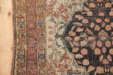 Fine weave detail of antique Farahan Sarouk rug: terracotta border, ivory field, navy spandrel floral design.