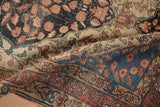 Artful corner detail of an antique Farahan Sarouk rug with sapphire blue and terracotta motifs.