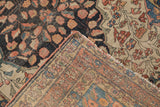 Antique Farahan Sarouk rug corner showing finely woven back and worn navy coral floral pile.