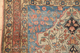 Finely woven rose-terracotta border, delicate vinery, and sapphire blue spandrel on an antique Sarouk rug.