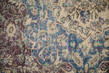 Worn floral arabesque pattern on a vintage Distressed Sparta carpet in cobalt blue and violet.