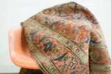 Unusual scrolling arabesques border with tribal Herati motifs on a shabby antique Persian rug.