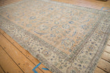 Distressed Sparta carpet with faded camel field, cobalt blue Herati design, and ivory border.